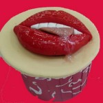 Pair of scrumptious lips teeth tongue cumin on a cup cake